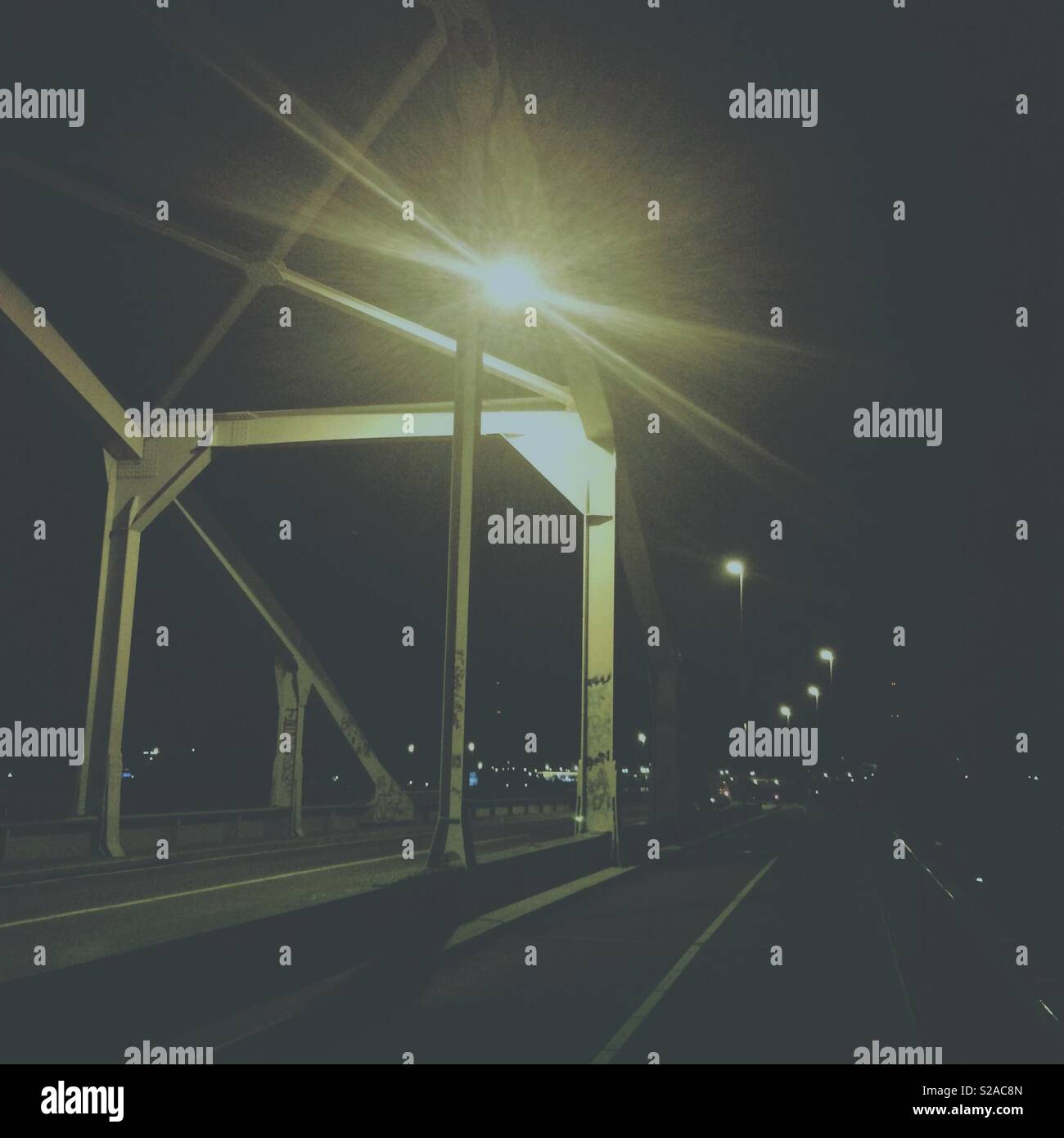 The night bridge - a street light and metal bridge structure scene - Smartphone Captured Stock Image
