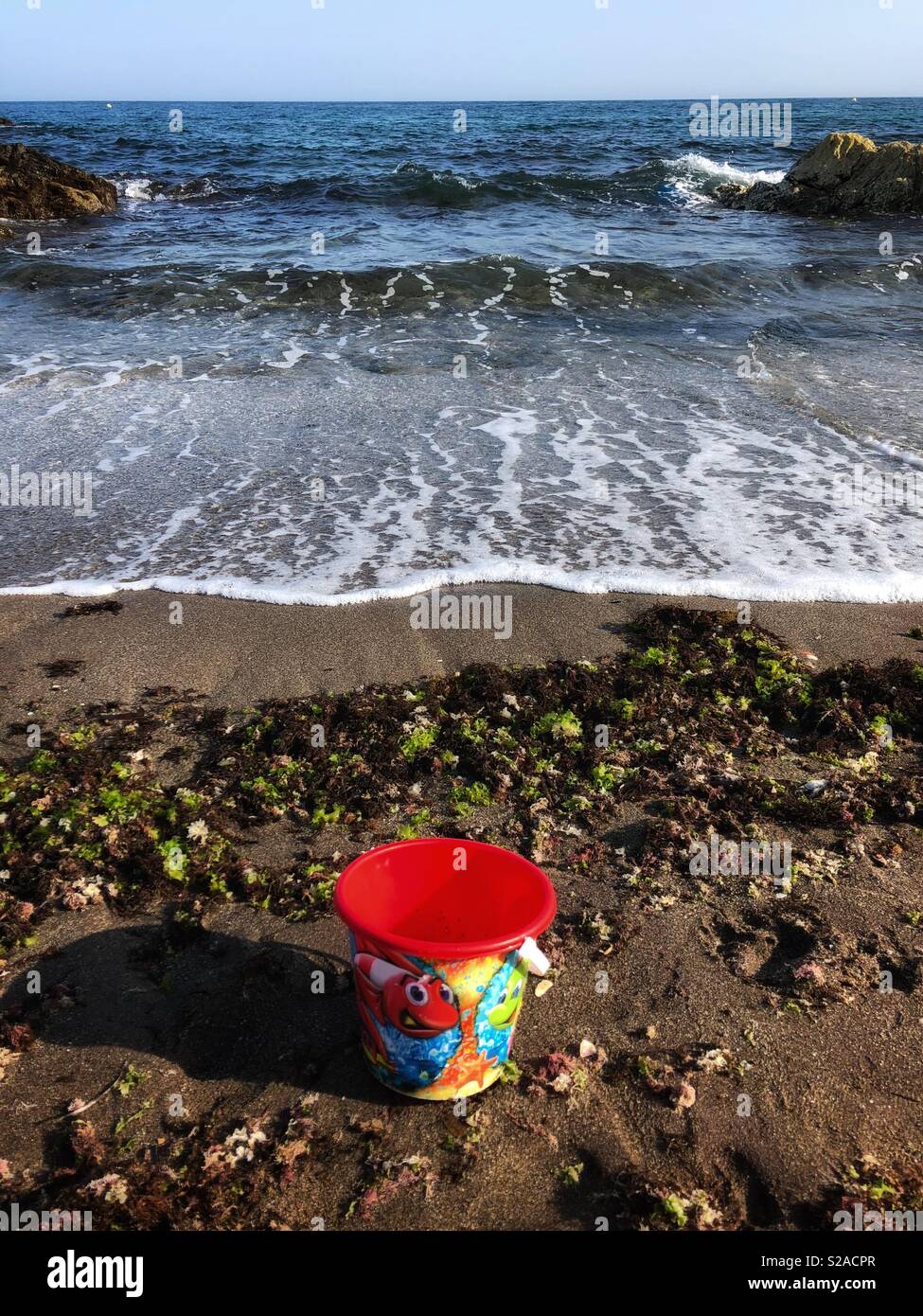 Sand bucket on the beach. Stock Photo