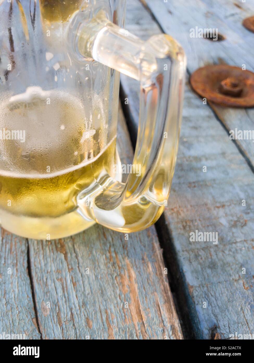 Glass of beer on rustic table outdoor Stock Photo