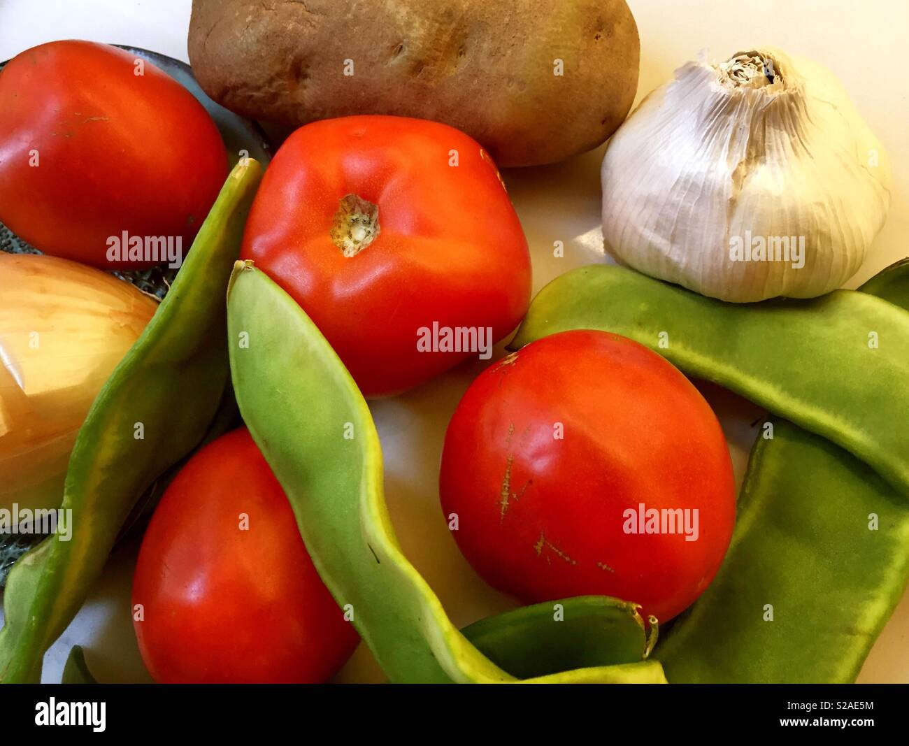 Still life of tomatoes, lima beans, garlic, potato and onion, USA - Smartphone Captured Stock Image