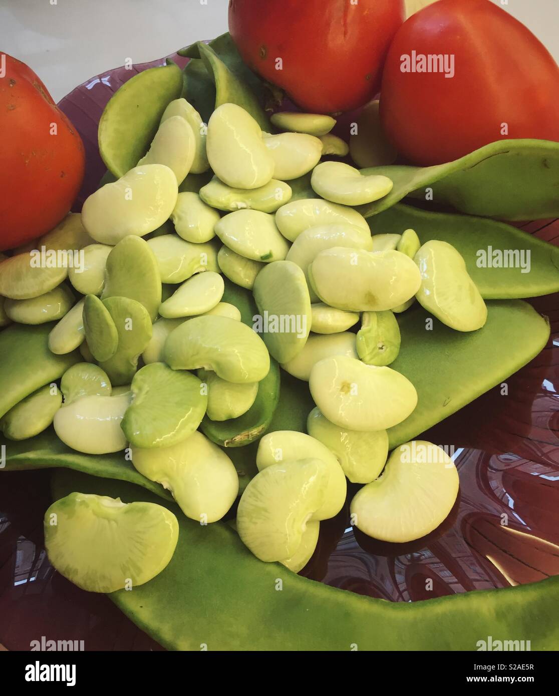 Still life of Dr. Martin heirloom lima beans and tomatoes, USA - Smartphone Captured Stock Image