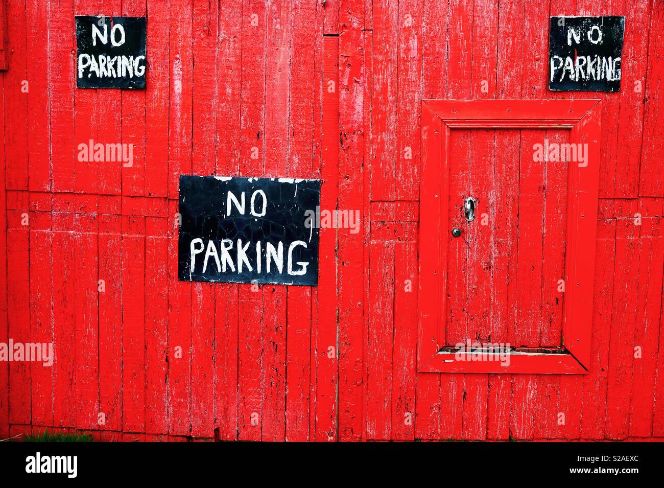 Park here at your peril!! A red door spotted at Ballywalter, County Down Stock Photo