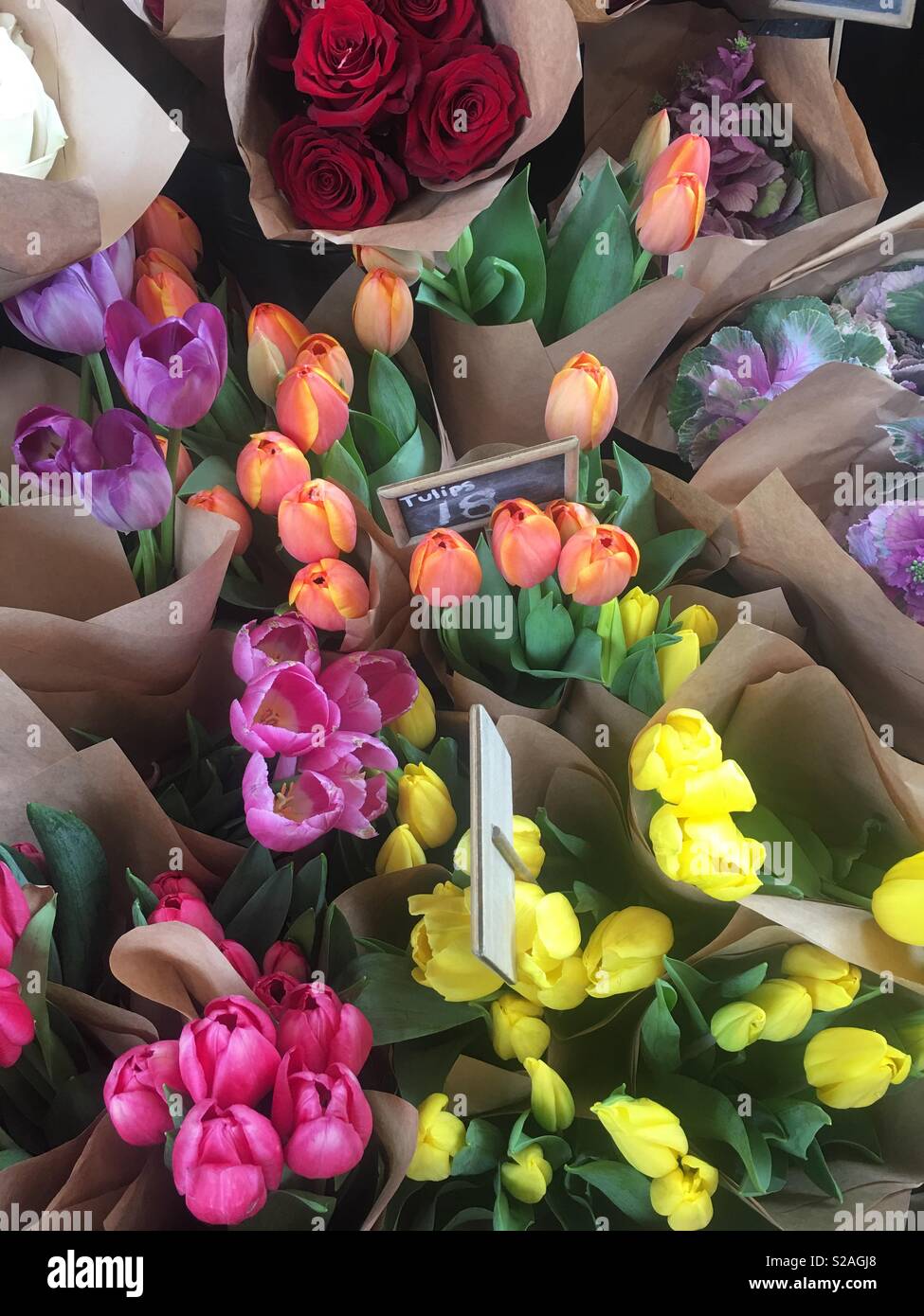 Colourful bunches of flowers displayed in front of florist at indoor
