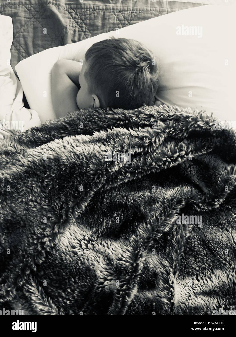 Sleeping peacefully sleeping child snuggled on a bright white