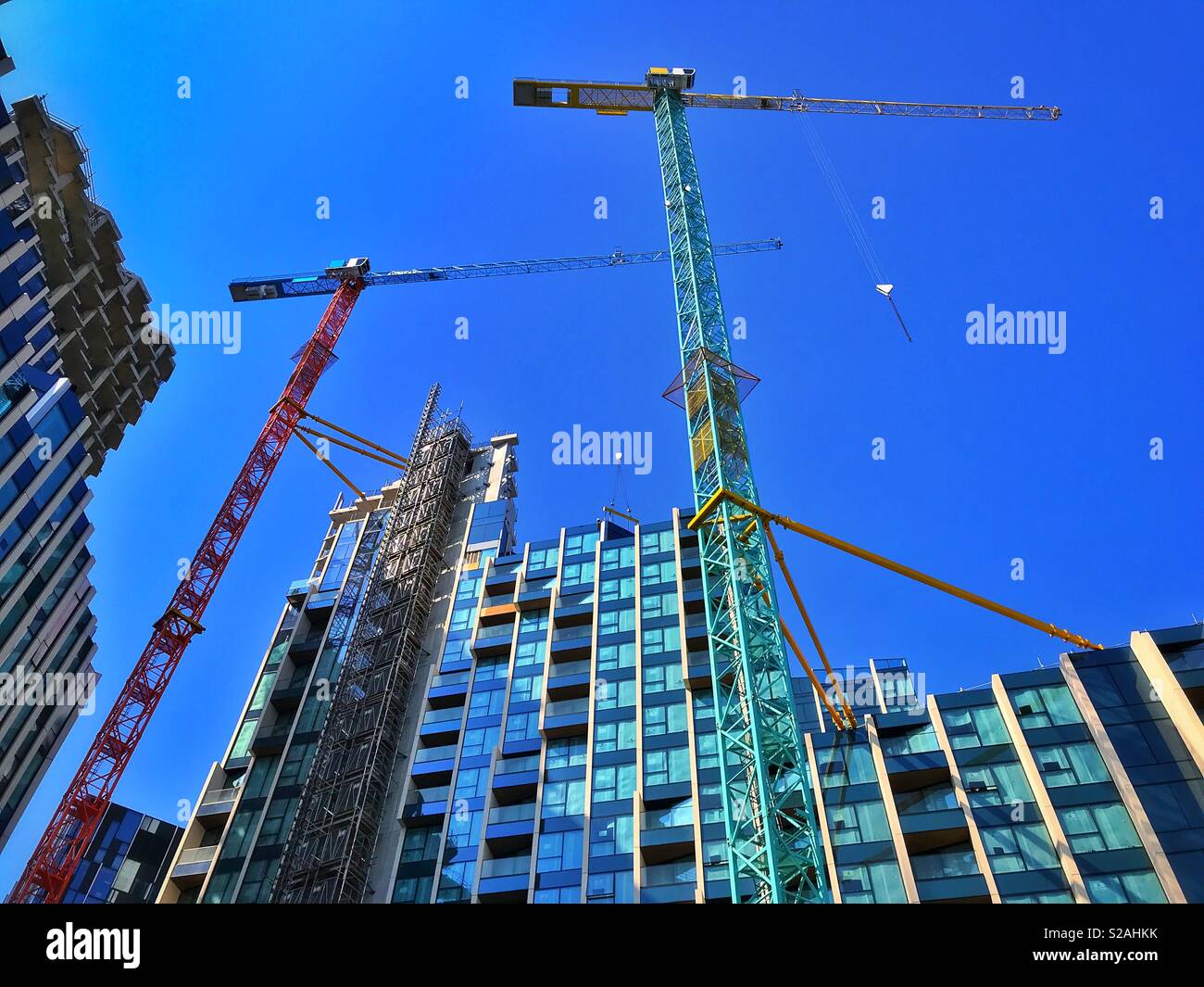 Looking up at the construction of high rise homes and apartments. A growing population means more people who needs more homes. Photo Credit - © COLIN HOSKINS. - Smartphone Captured Stock Image