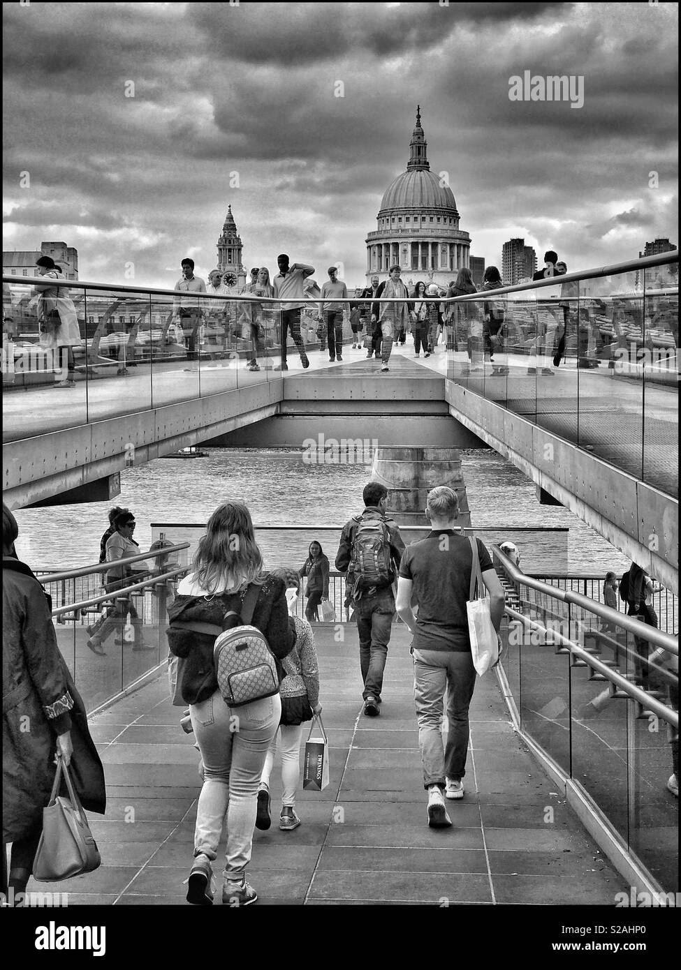Looking north from the South Bank of The River Thames along The Millennium Bridge toward St. Paul’s Cathedral. Thousands of people walk over this iconic bridge every day. Photo Credit -© COLIN HOSKINS Stock Photo