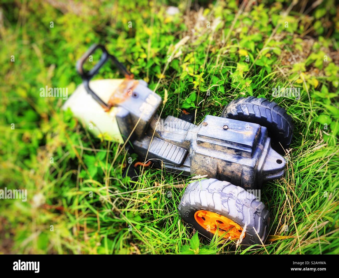 Abandoned ride on toy tractor - Smartphone Captured Stock Image