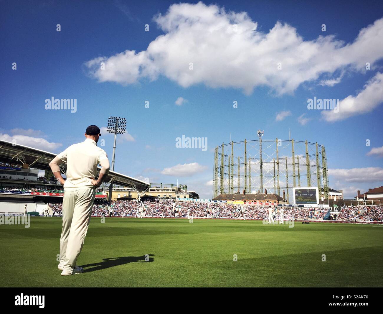 A cricketer stands near the boundary rope during a cricket match at the Kia Oval in London. Stock Photo