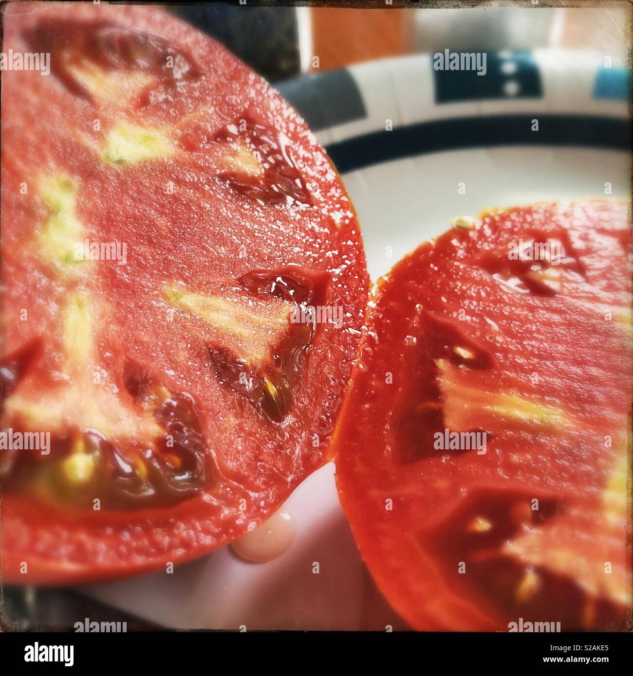 A tomato cut into halves using Hipstamatic. - Smartphone Captured Stock Image