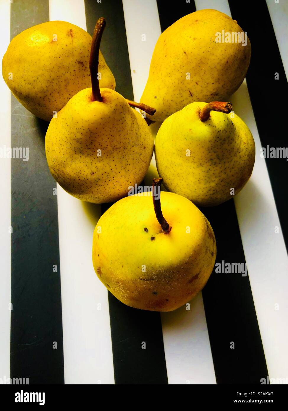 Yellow pears against black and white background - Smartphone Captured Stock Image