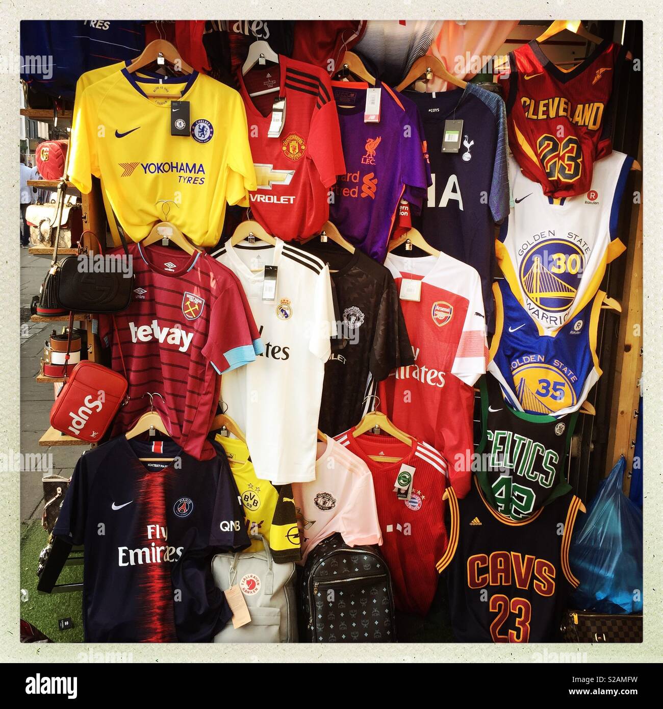 Market stall selling football shirts Stock Photo - Alamy