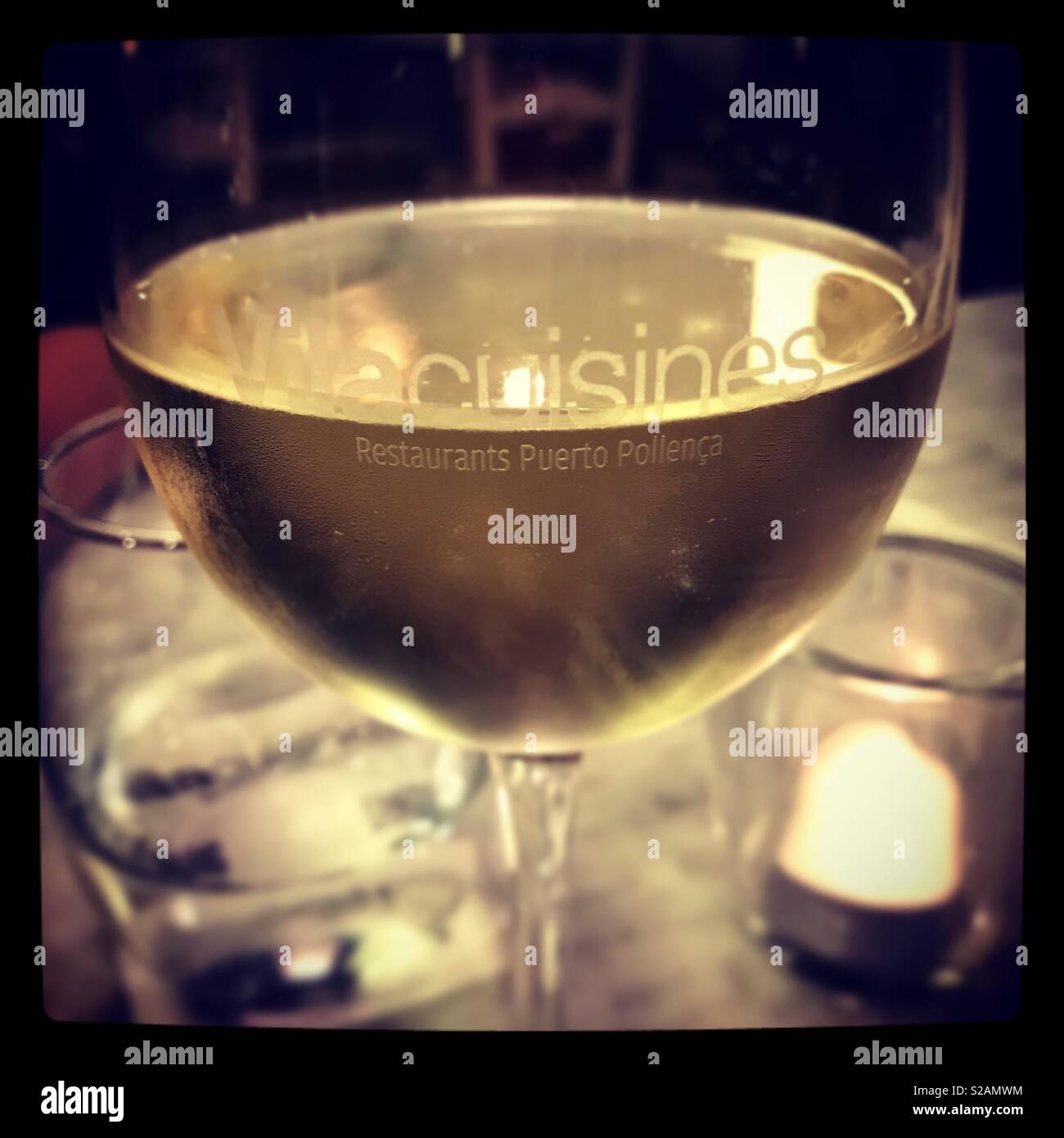 Glass of white wine in a restaurant Stock Photo
