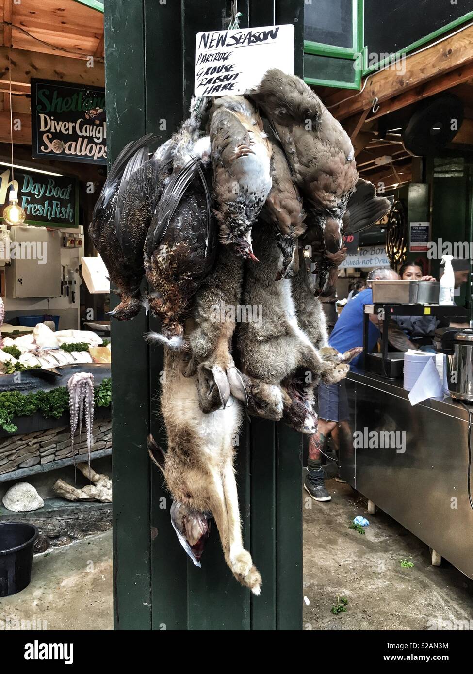 Partridge Goose and Rabbit for sale at Borough Market in London, England - Smartphone Captured Stock Image