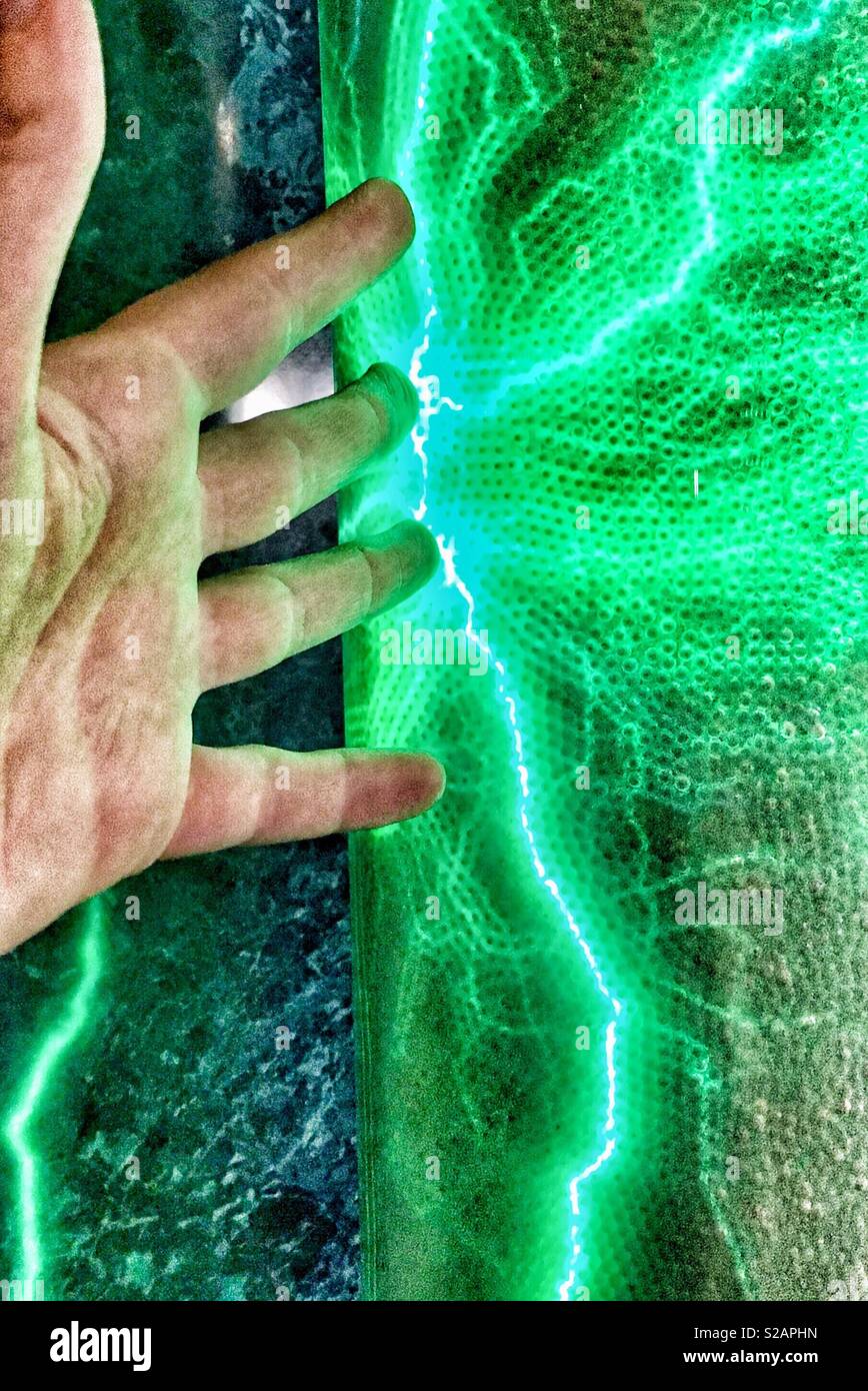Person touching green plasma tube - Smartphone Captured Stock Image