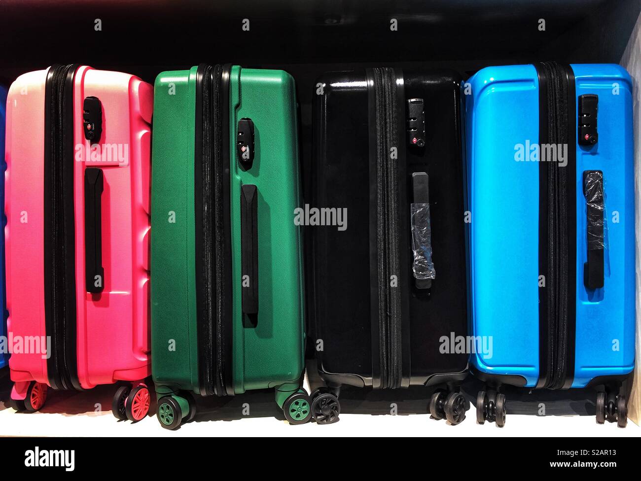 Colourful luggage bags in a row! Travels and vacations! Stock Photo