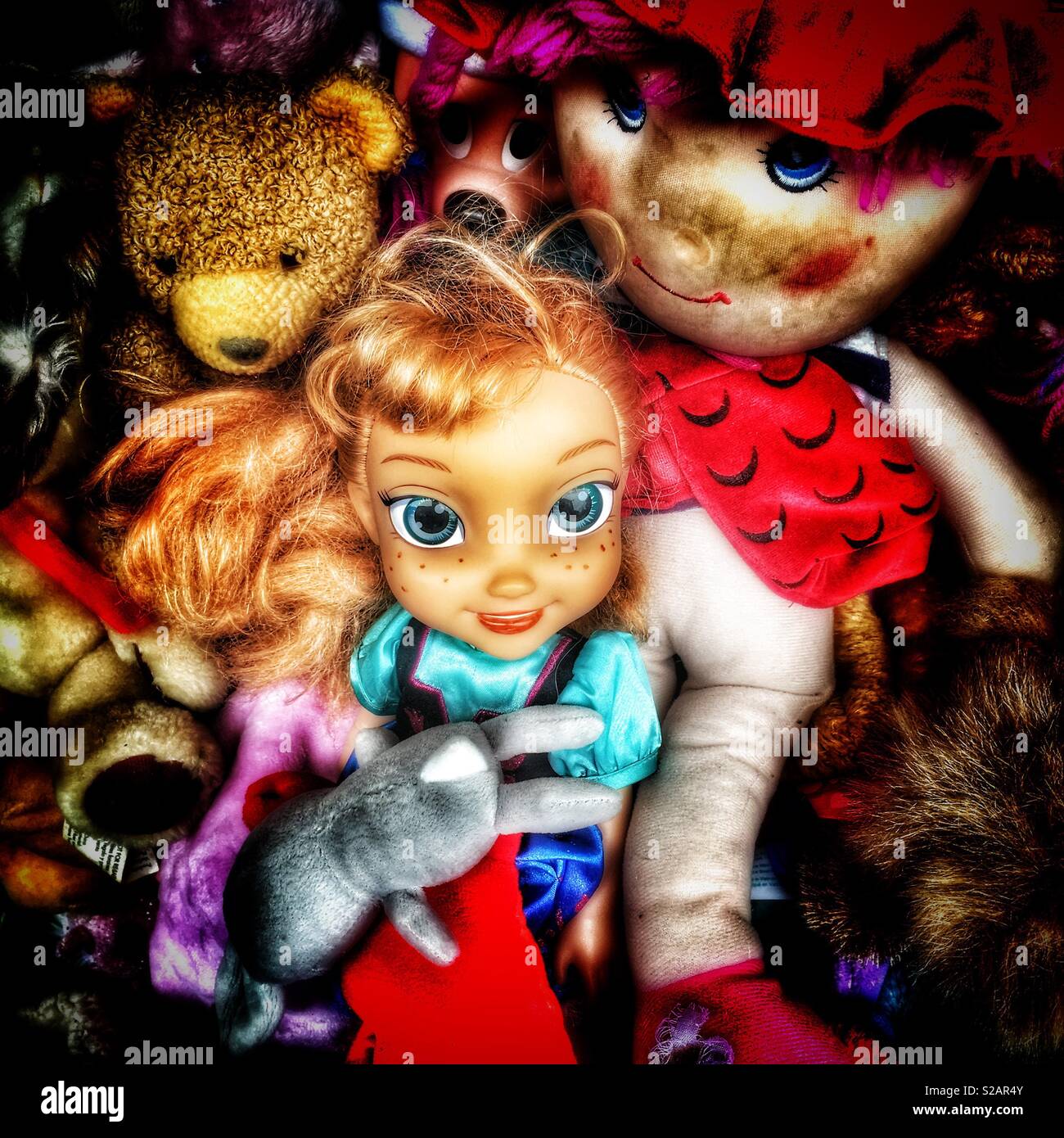 Dolls in basket and for sale in charity shop - Smartphone Captured Stock Image
