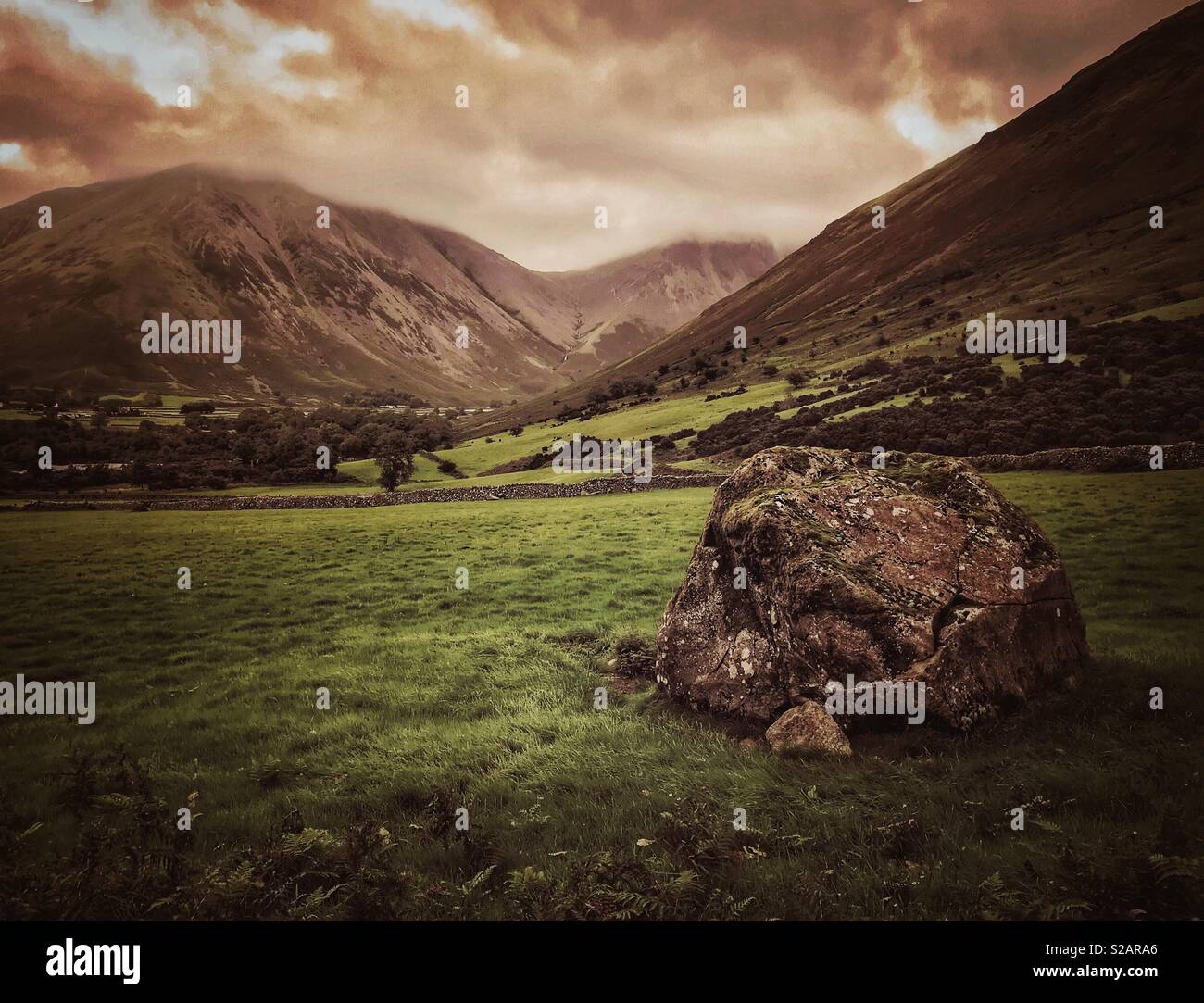 Bolder, field and mountains in the Lake District National Park, Cumbria, England - Smartphone Captured Stock Image