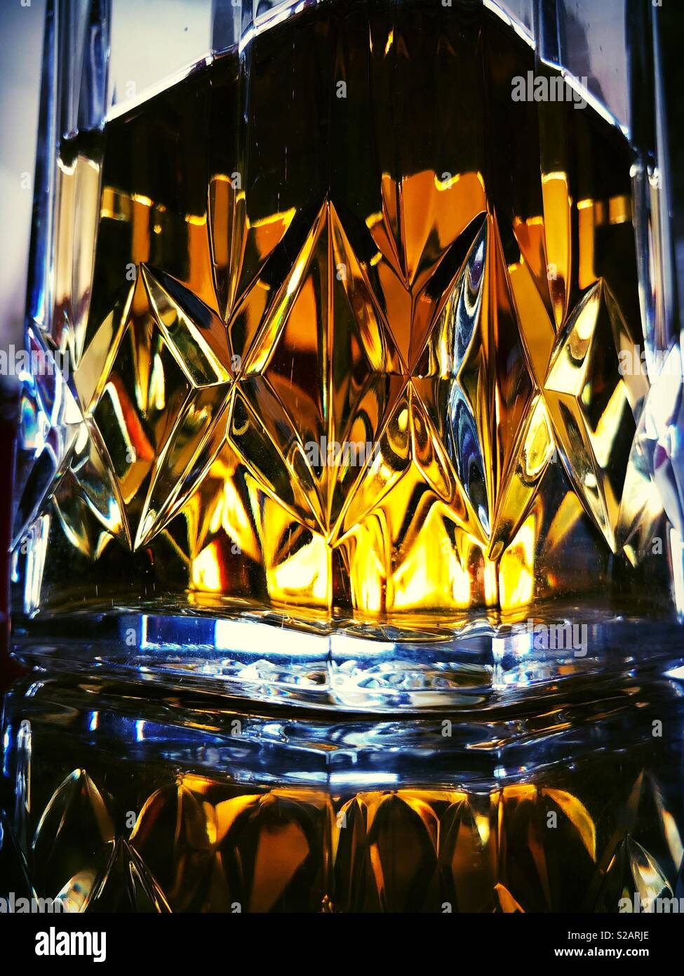 Crystal whiskey decanter with natural light shining through it - Smartphone Captured Stock Image