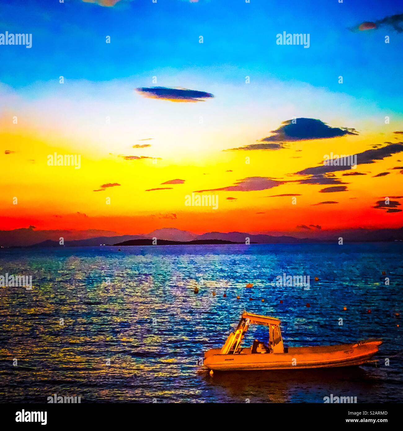 Sunset and yellow boat Voulagmeni Athens Greece Stock Photo