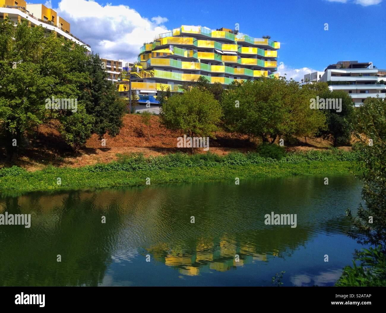 Reflection of the new modern building Koh-I-Noor in the river Lez, Montpellier France - Smartphone Captured Stock Image