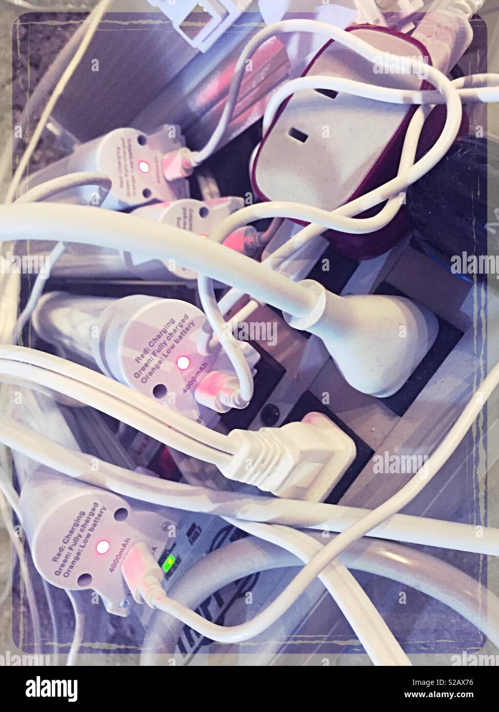 Close up of many plugs in many power strips, close up, USA - Smartphone Captured Stock Image
