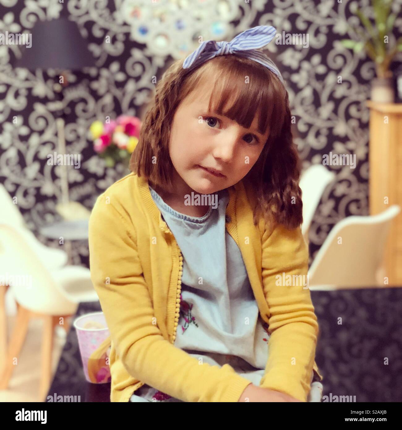 Girl in a yellow cardigan Stock Photo Alamy