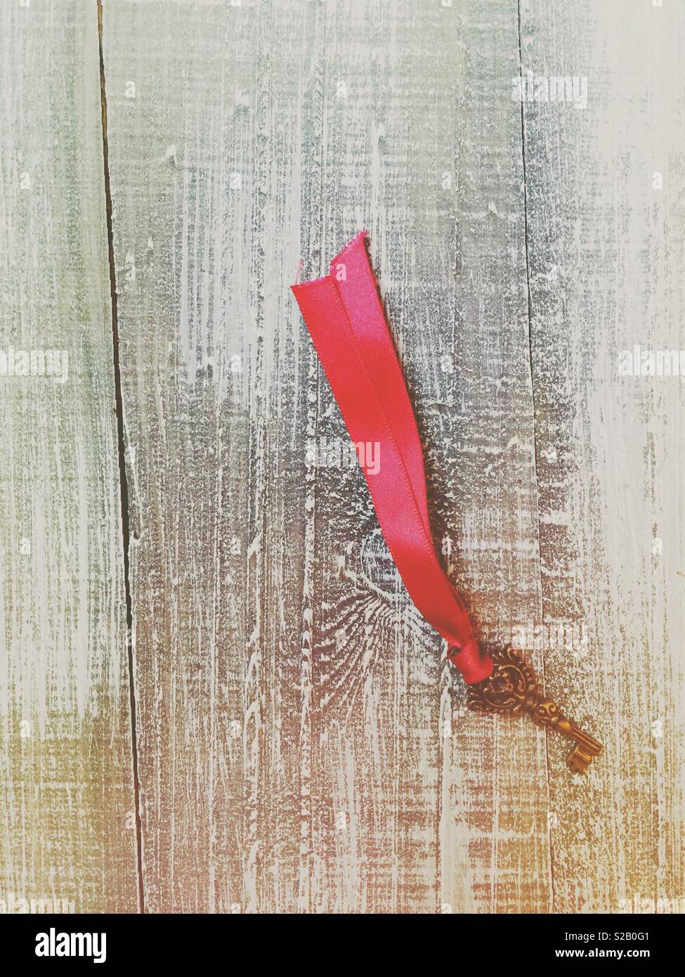 Old little vintage key with red ribbon - Smartphone Captured Stock Image