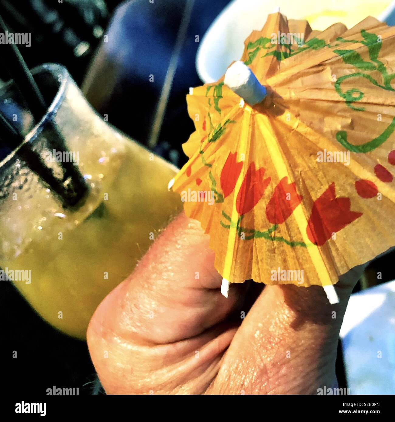 Exotic tropical Mai Tai with paper cocktail umbrella at a tiki bar in Hawaii - Smartphone Captured Stock Image