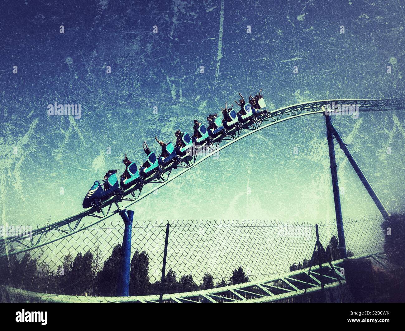 People in roller coaster sliding down fast in Park Asterix Paris France - Smartphone Captured Stock Image