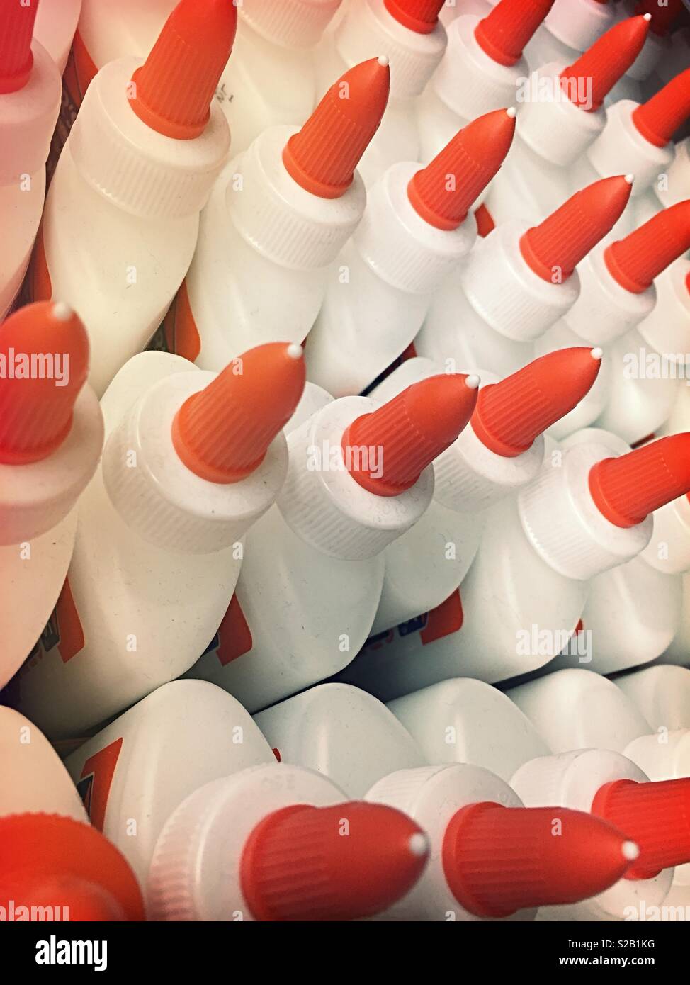 Rows and-rows of plastic glue bottles for sale, USA - Smartphone Captured Stock Image