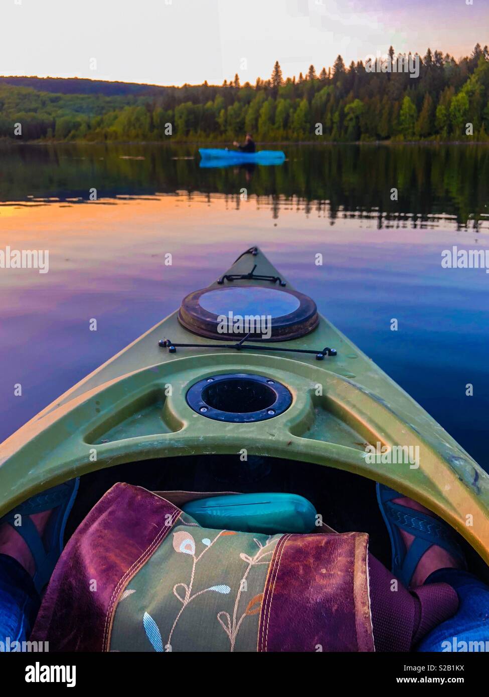 Kayaking on the pond. A fisherman fishes from his kayak. - Smartphone Captured Stock Image