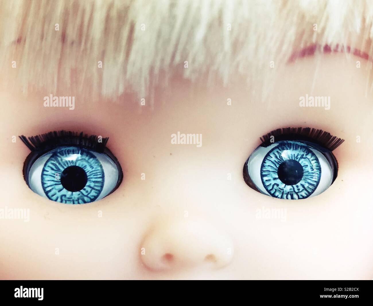 Close up of a doll’s big blue eyes. Stock Photo