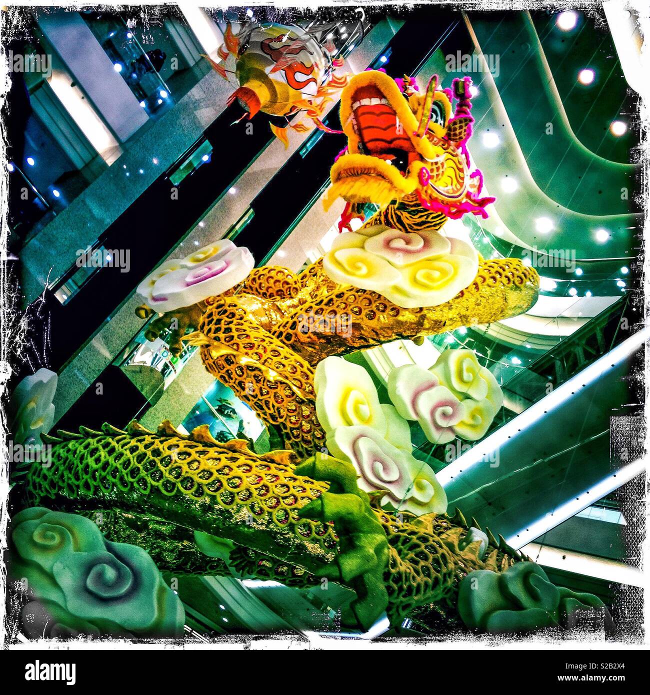 Sculpture of dragon celebrating Chinese New Year suspended in the multi-storey atrium of Times Square shopping mall, Causeway Bay, Hong Kong Island - Smartphone Captured Stock Image