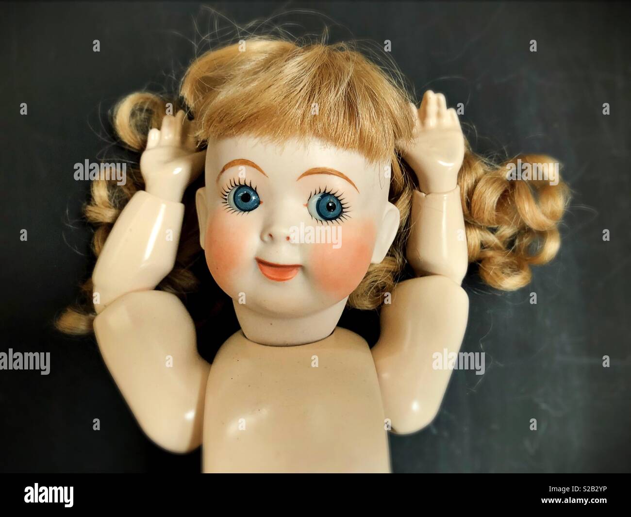 Doll with arms raised. Stock Photo