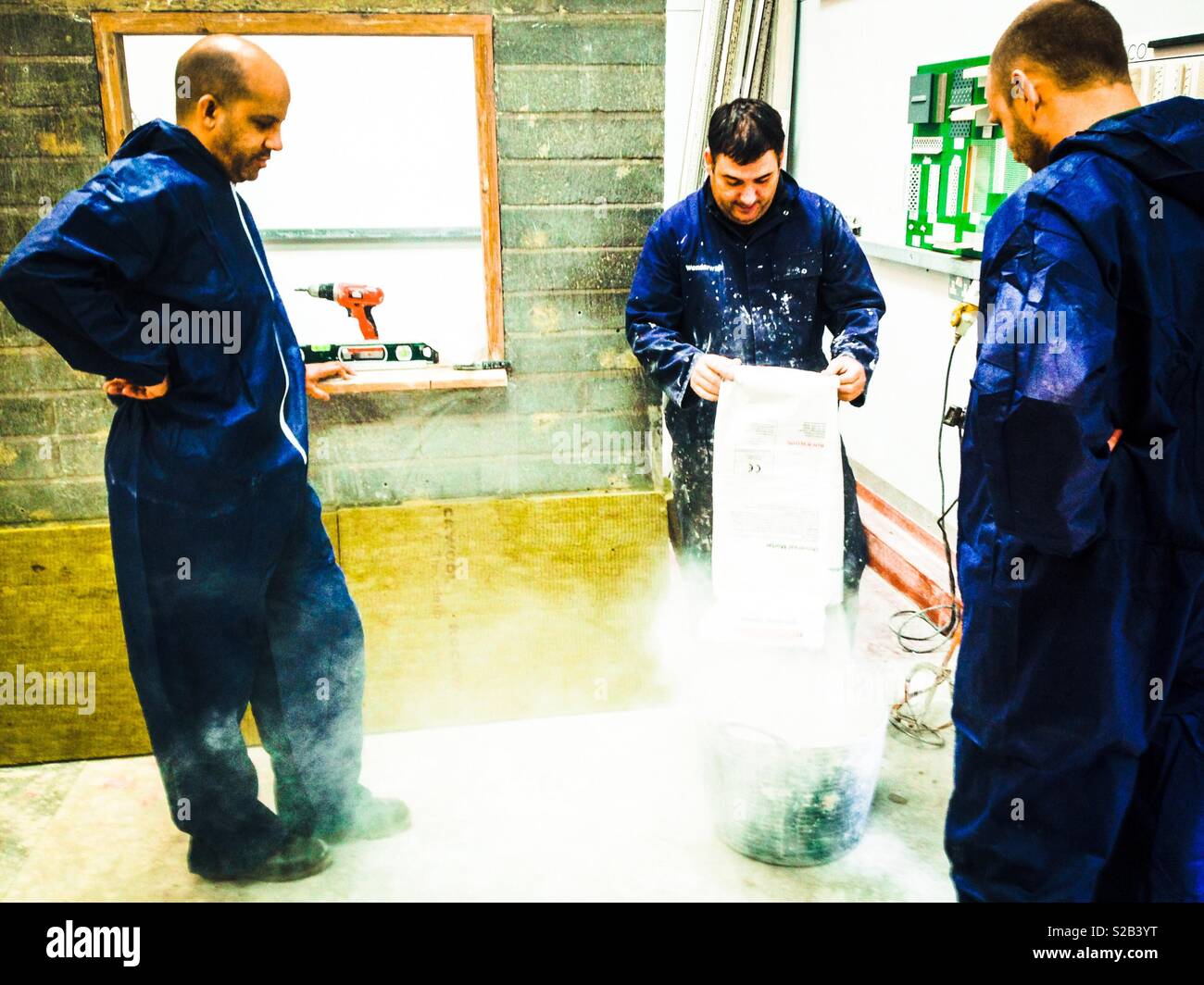 Workers working Wearing blue overalls - Smartphone Captured Stock Image