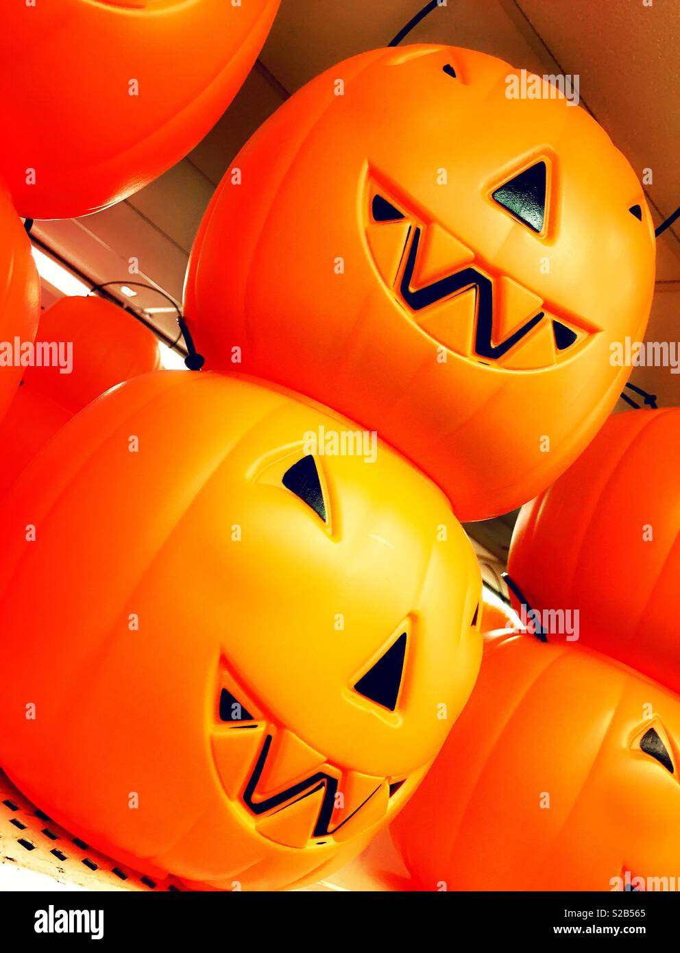Halloween candy trick-or-treat buckets in the shape of orange jack-o’-lanterns, USA - Smartphone Captured Stock Image