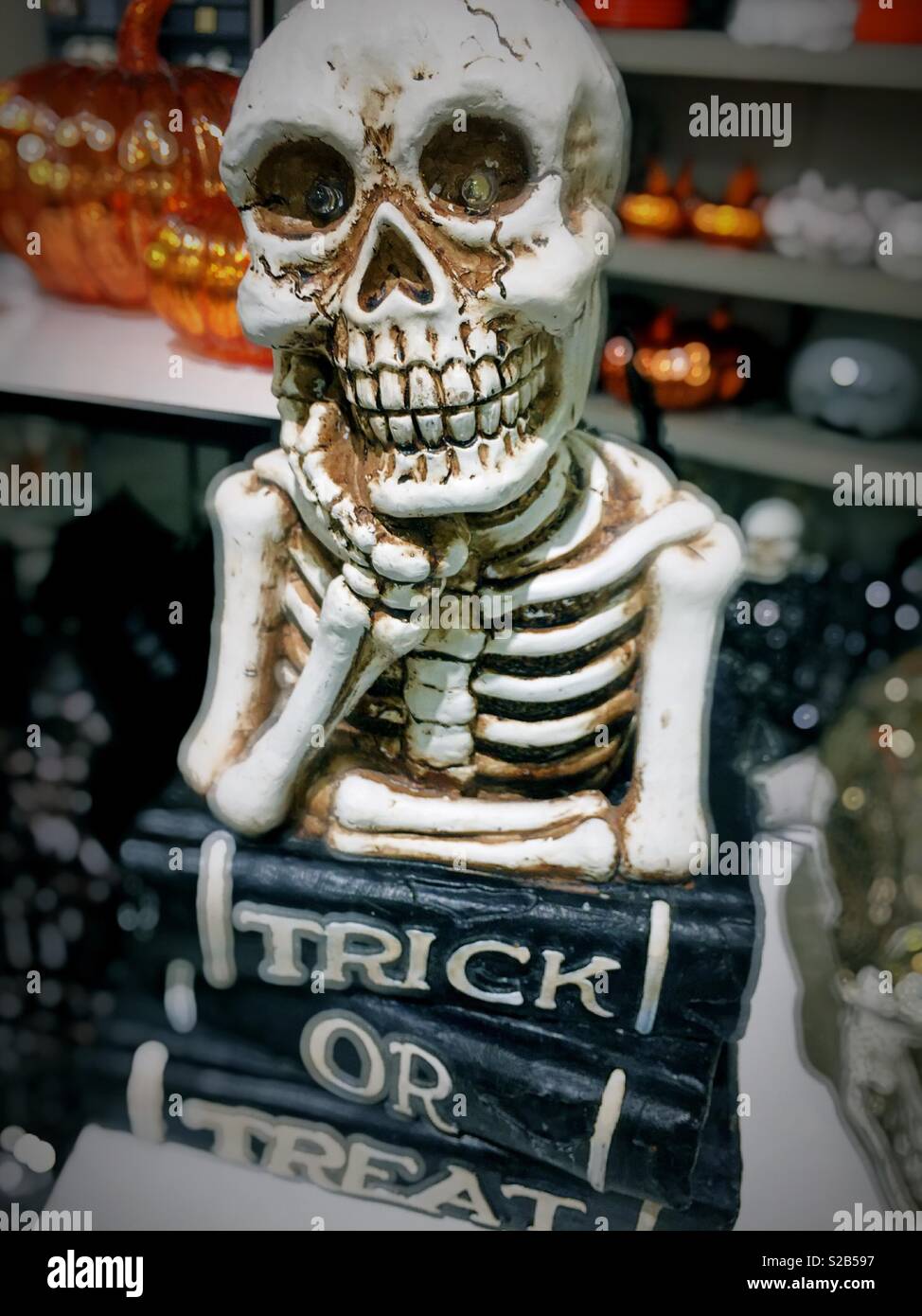 Halloween decorative piece of skeleton and sign declaring trick or treat, USA - Smartphone Captured Stock Image