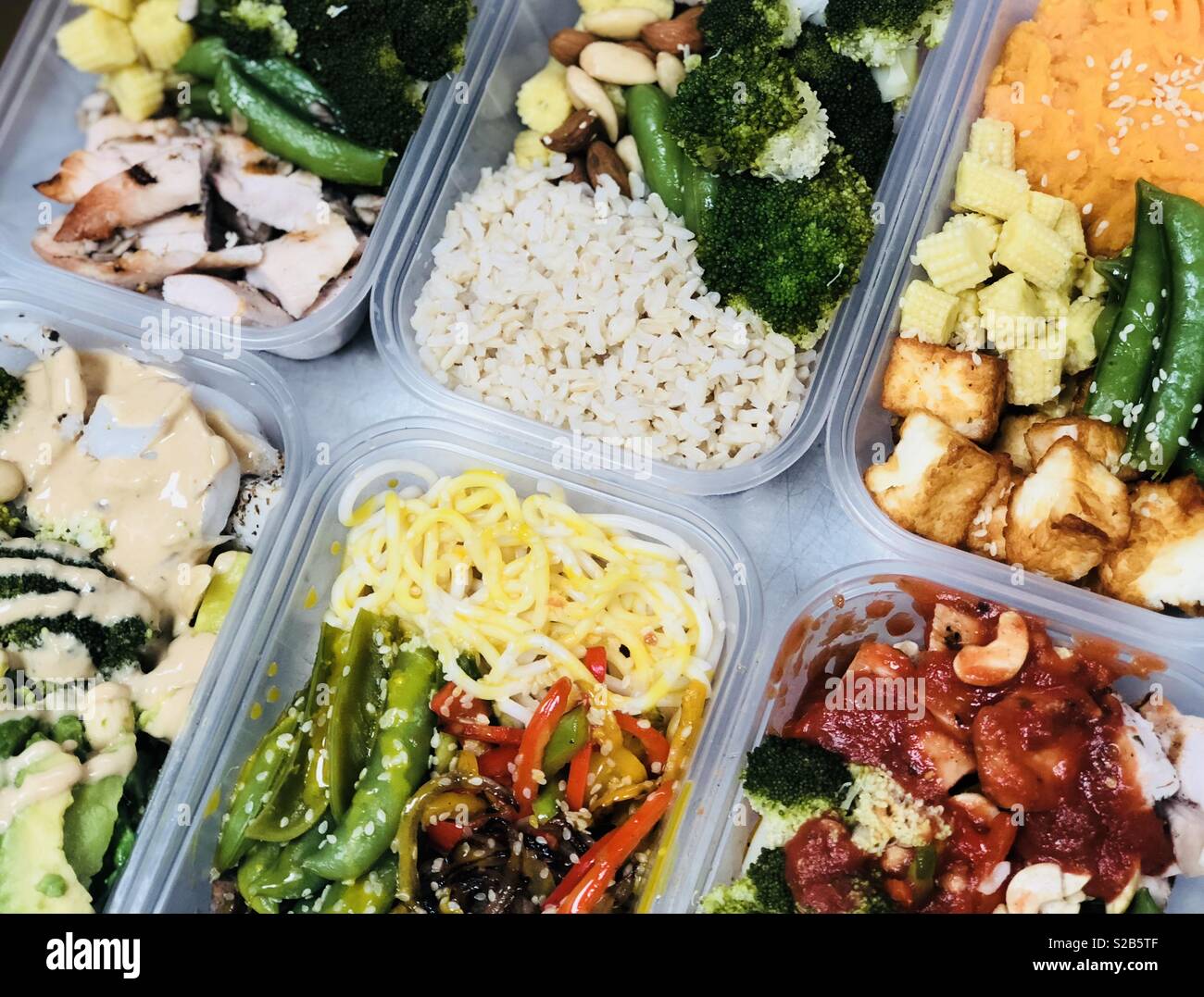 Meal prep containers with rice with chicken, baked vegetables, eggs,  sausages and salad for breakfast and lunch overhead shot Stock Photo - Alamy