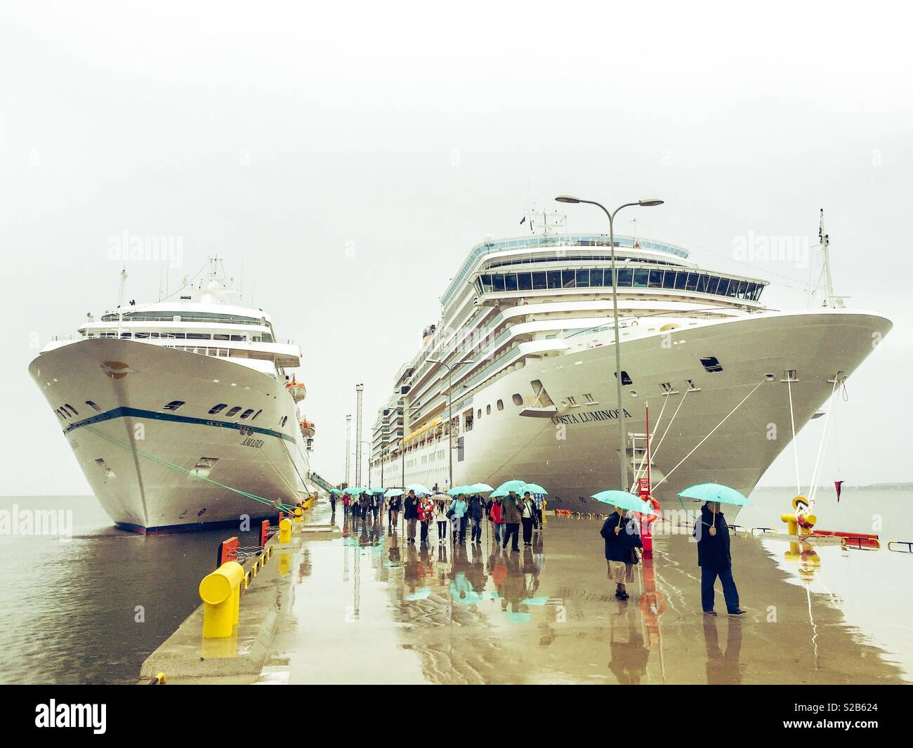 Cruise ships docked together while raining Stock Photo