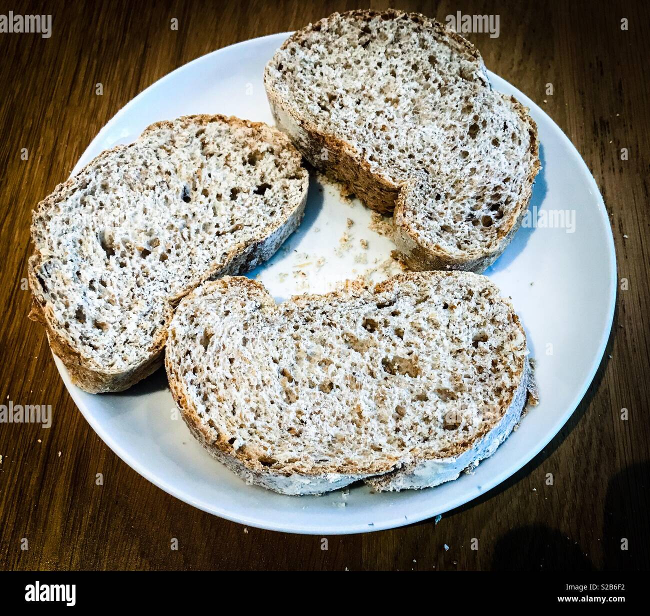 Three slices of wholemeal bread on a white plate - Smartphone Captured Stock Image