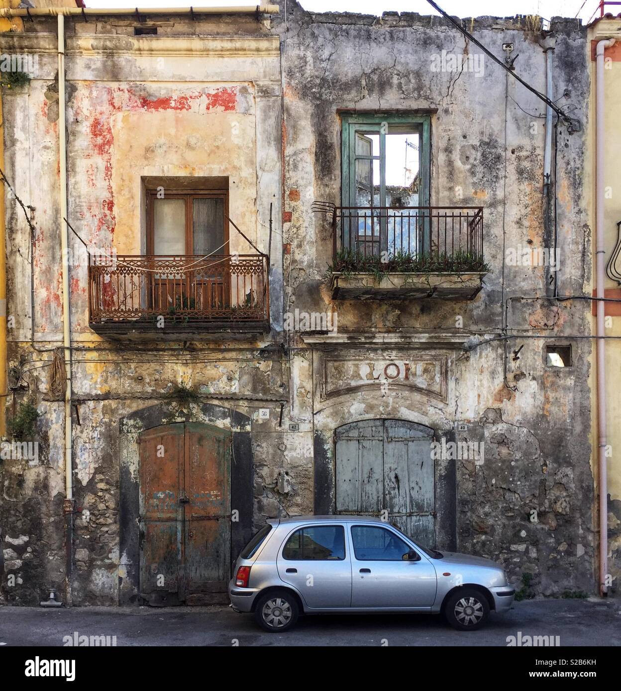 Car parked in front of an old building in Angri, a small town in the Campania region of southern Italy Stock Photo
