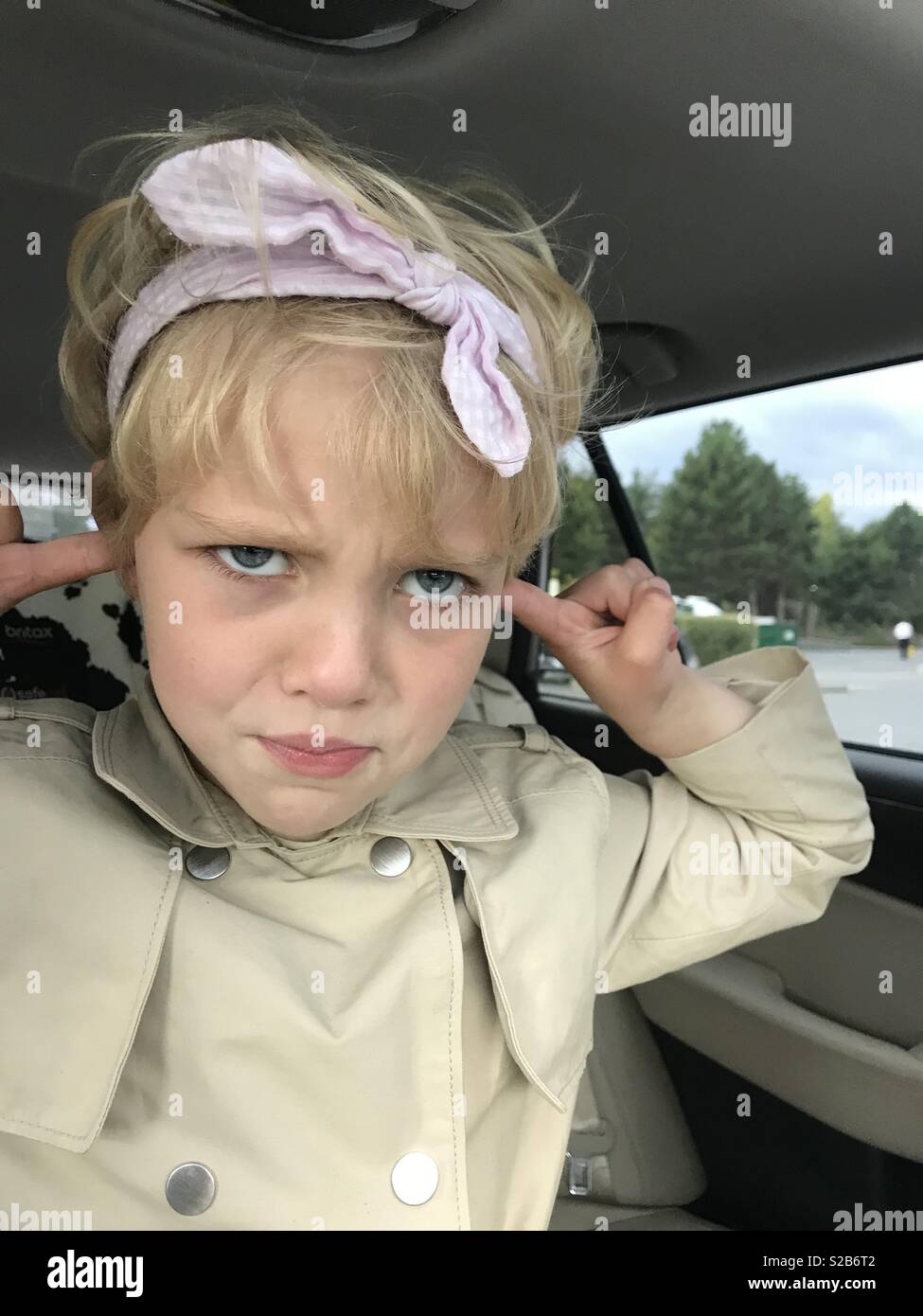 A young girl plugs her ears on a family road trip and refuses to listen
