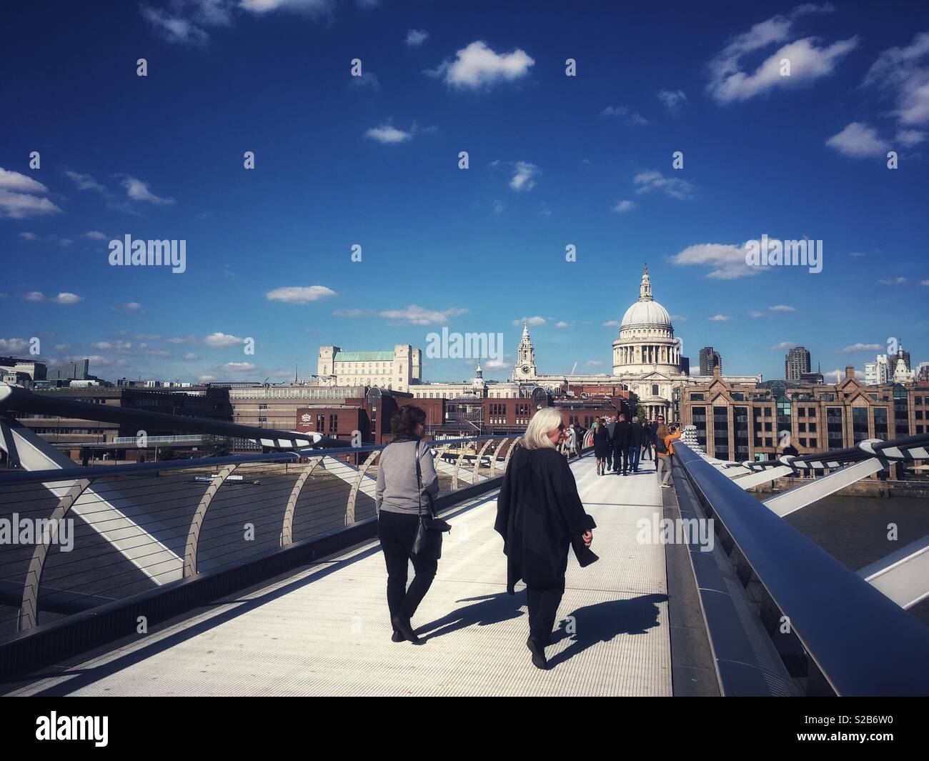 People walk across the Millennium bridge in London, England on September 25 2018 - Smartphone Captured Stock Image