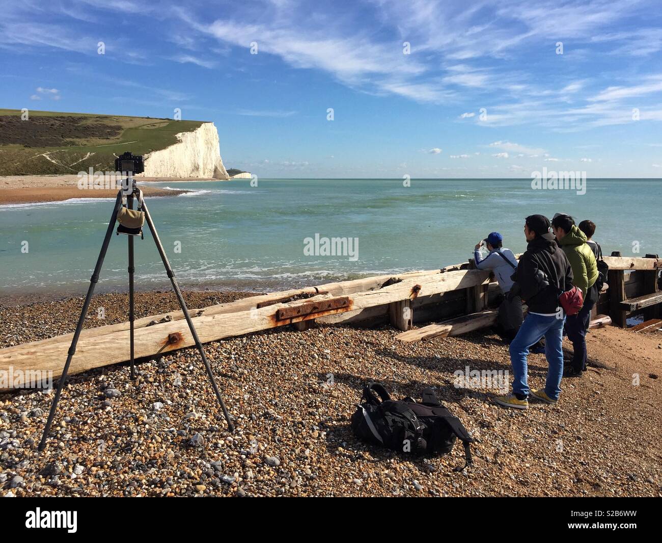 Tourists taking a picture of the Seven Sisters from Cuckmere Haven beach Stock Photo