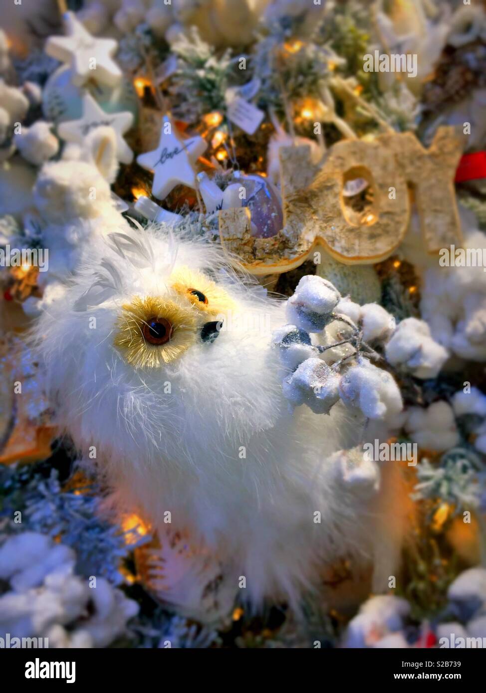 Fluffy white snow owl ornament hanging on a Christmas tree, USA - Smartphone Captured Stock Image