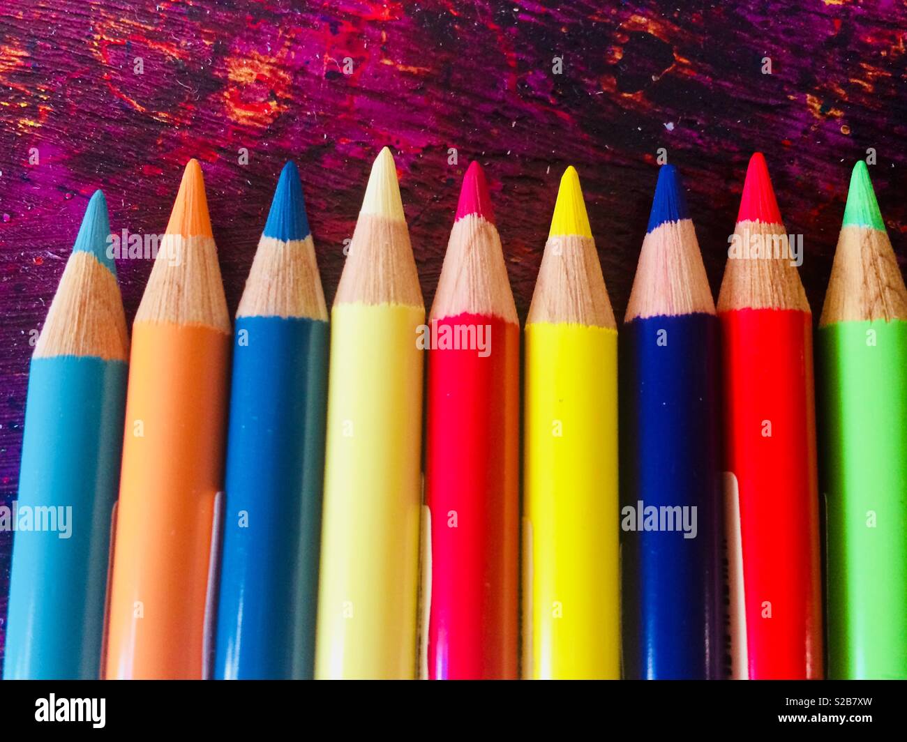 Colouring pencils on a purple background Stock Photo - Alamy