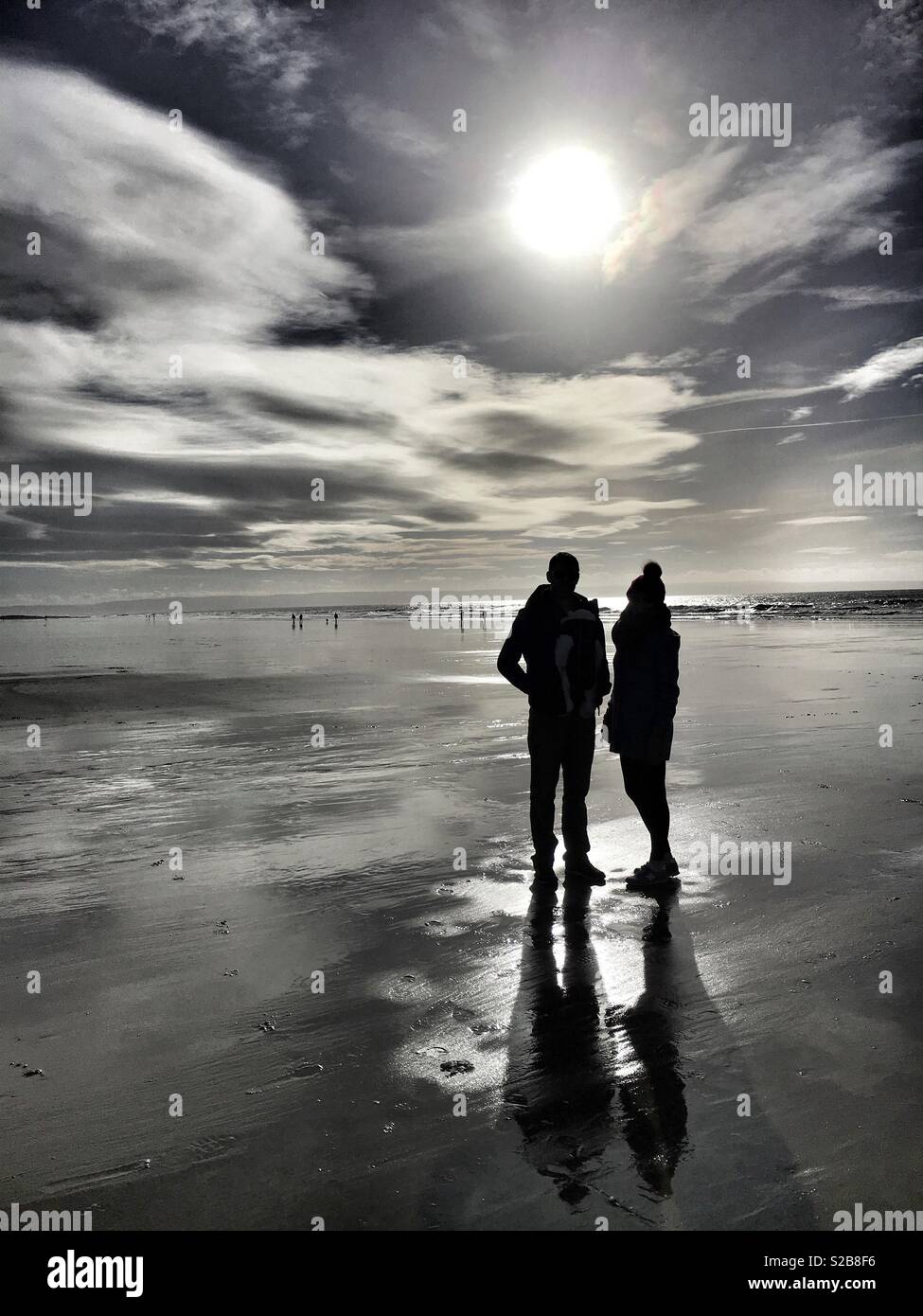 Silhouette of a couple on a beach Stock Photo - Alamy