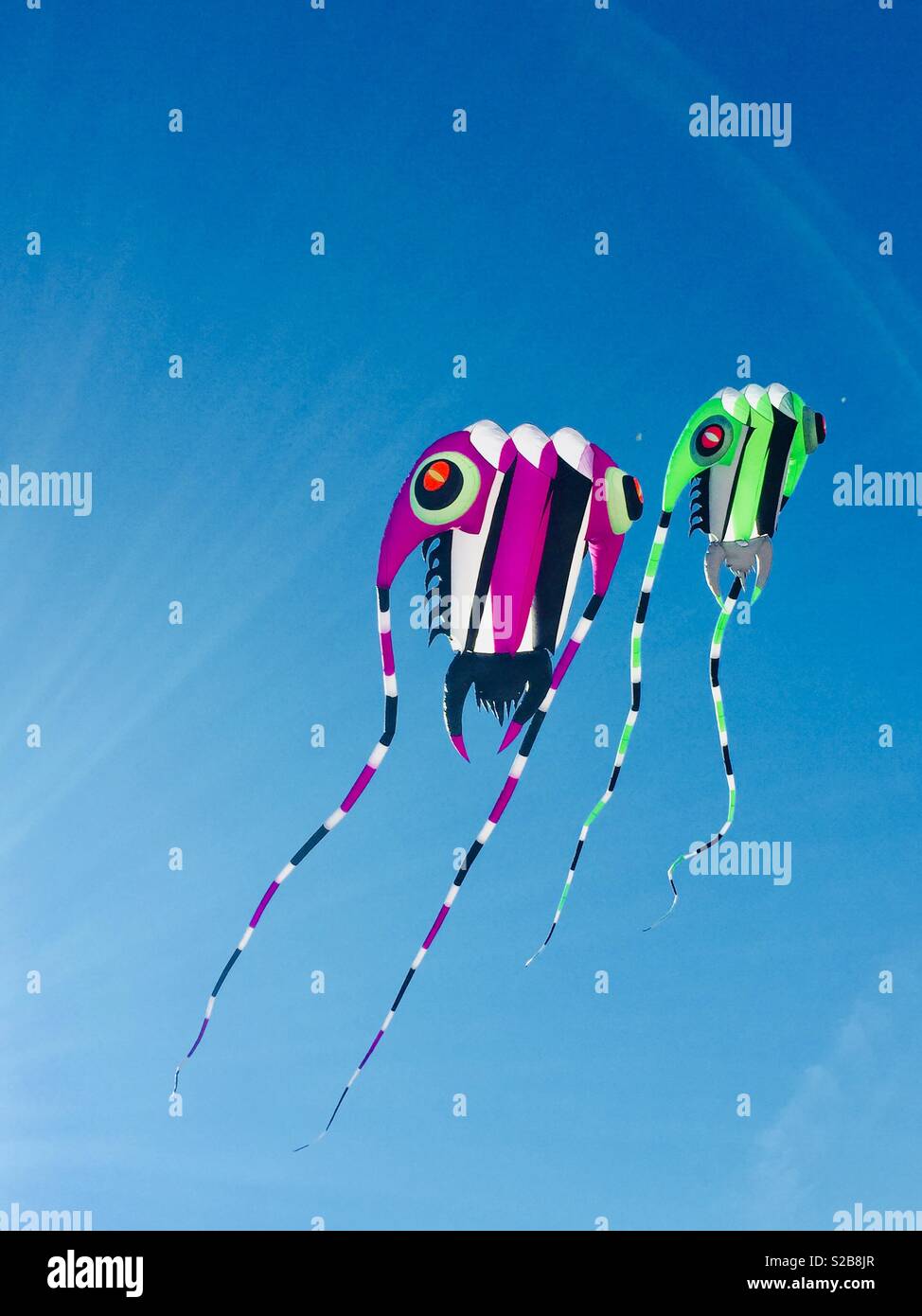 Two brightly coloured kites - Smartphone Captured Stock Image