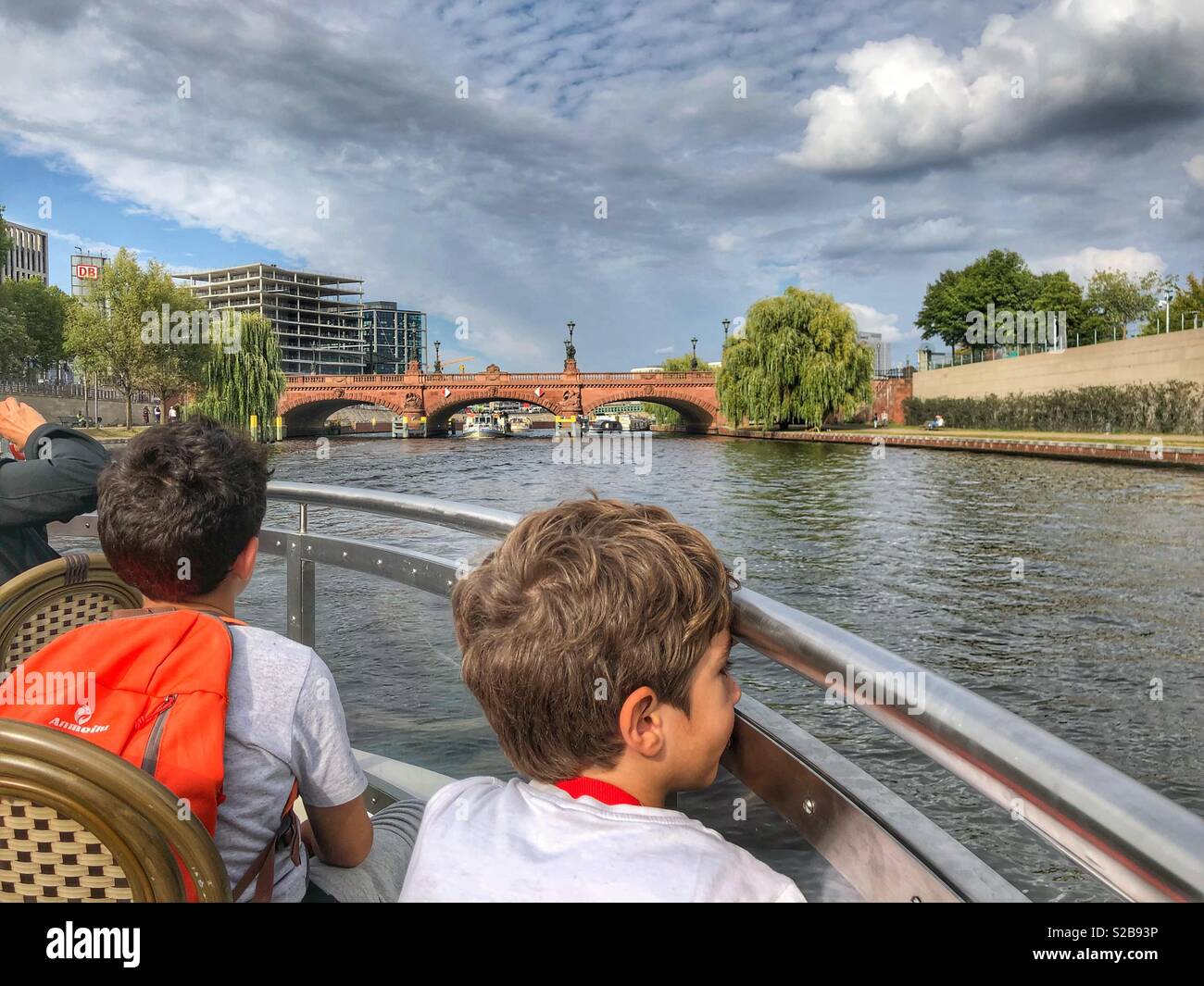 Two tourist boys enjoying Spree river cruise - Berlin Germany - Smartphone Captured Stock Image