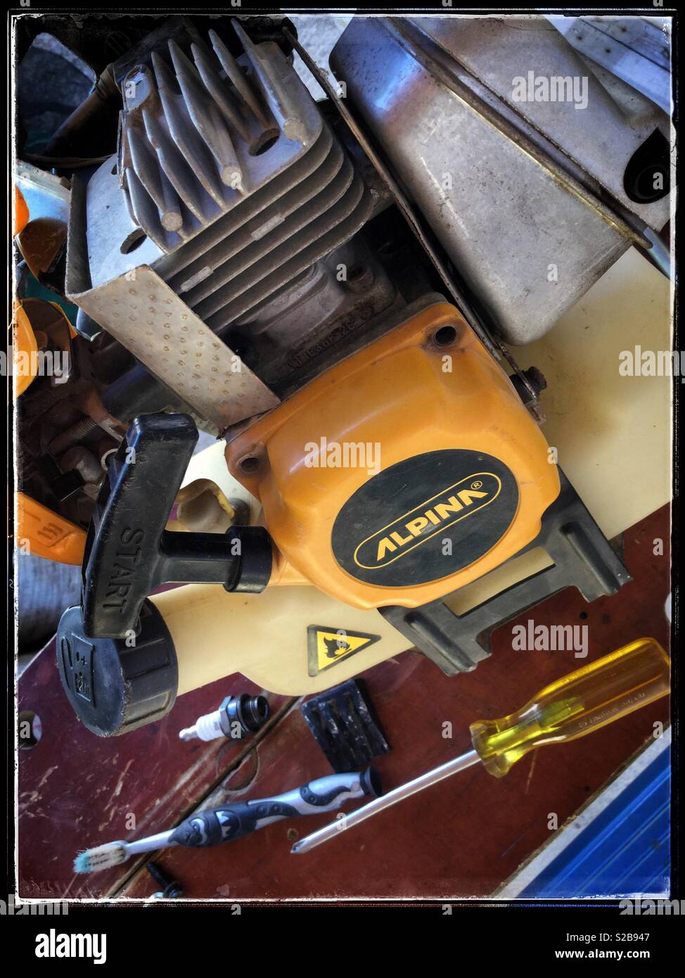 Fixing an Alpina brush-cutter, Catalonia, Spain. Stock Photo